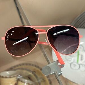 pink-framed aviator sunglasses feature rhinestone embellishments on the lenses.